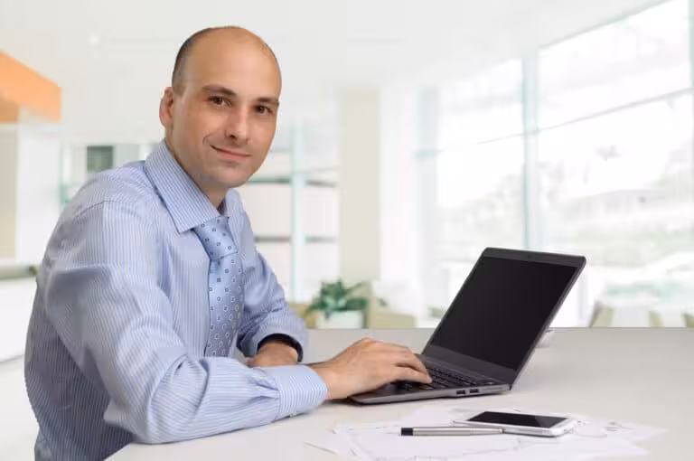 MItarbeiterzufriedenheit Mann am Laptop Laecheln